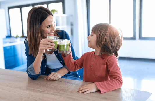 A woman and child enjoying a healthy green drink 